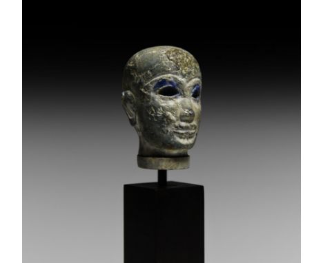 3rd-2nd millennium BC. A head of a nobleman or prince, carved in lapis lazuli; facial features formed in a stylised but semi-