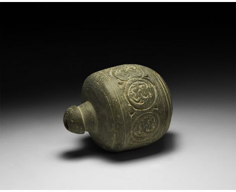 9th-11th century AD. A carinated ceramic vessel with short neck, domed lip and conical base, decorated with a circumferential