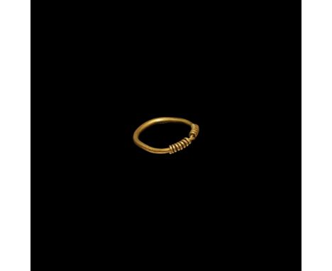 9th-11th century AD. A ring with gold round-section hoop and bezel formed from coiled sleeves.  5.69 grams, 29.82mm overall, 