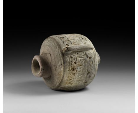 9th-11th century AD. A highly decorated ceramic carinated vessel with restored rim and broad shoulder with a circumferential 