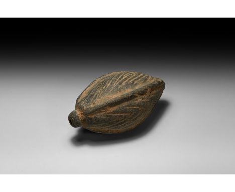 9th-11th century AD. A fusiform ceramic vessel with short neck, domed lip, four thick vertical ribs with herringbone pattern 