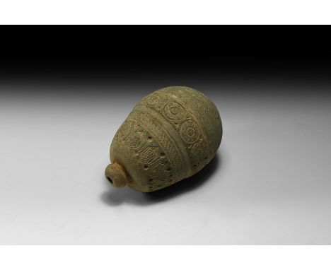 9th-11th century AD. A piriform ceramic vessel with short neck, domed lip and conical base, bands of impressed horizontal det