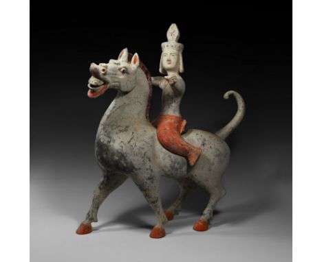 Han Dynasty, 206 BC-220 AD. A substantial ceramic figure of a mounted warrior; the horse stepping forward with head erect and