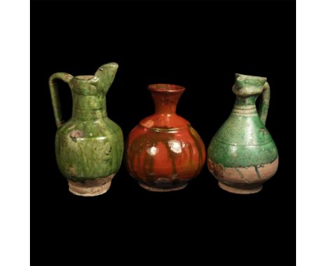 14th-15th century AD. A group of three part-glazed ceramic vessels comprising: a piriform ewer with trefoil mouth, strap hand