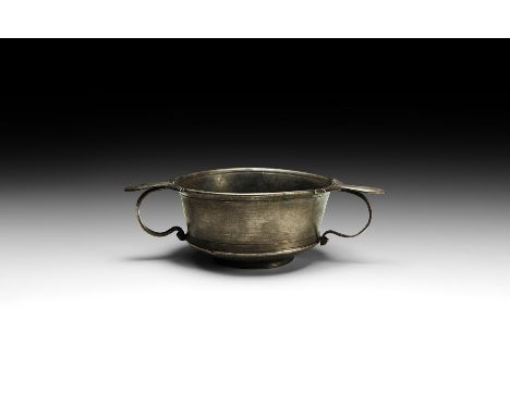 1st century BC-1st century AD. A silver skyphos with carinated body and basal ring, flared rim, two applied loop handles each