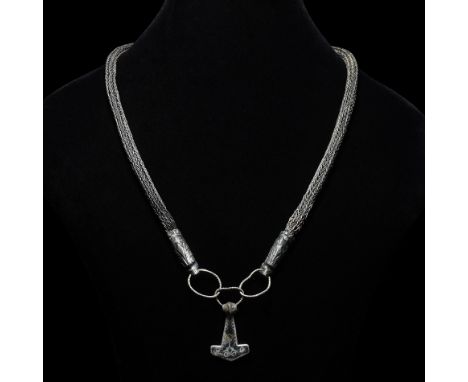 10th-12th century AD. A silver necklace with plaited round-section chain, beast head sleeves with niello detailing, three int