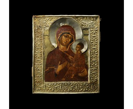 18th century AD. A wooden icon with two mounting slots and bars to the reverse; brass oklad cover with raised edges and repou