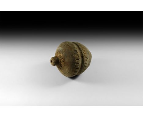 9th-11th century AD. A piriform ceramic vessel with short neck, domed lip and conical base, medial c-section groove flanked b