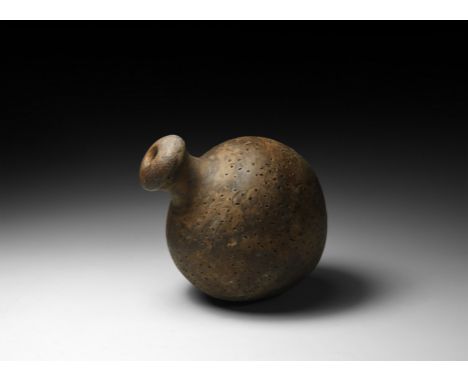 9th-11th century AD. A piriform ceramic vessel with waisted neck, domed lip and conical base, decorated over the body with 'p