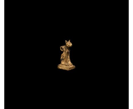 Third Intermediate Period, 1069-702 BC. A gold figure of a cat, Bastet, resting on a rectangular base, head erect with suspen