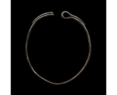 10th century AD. A massive iron warrior necklace made of thick iron wire, ring-shaped, with a loop-and-hook to the finials. S