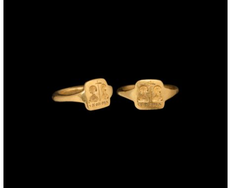 6th-8th century AD. A gold finger ring with square bezel divided by a median cross flanked by two facing portrait busts and '