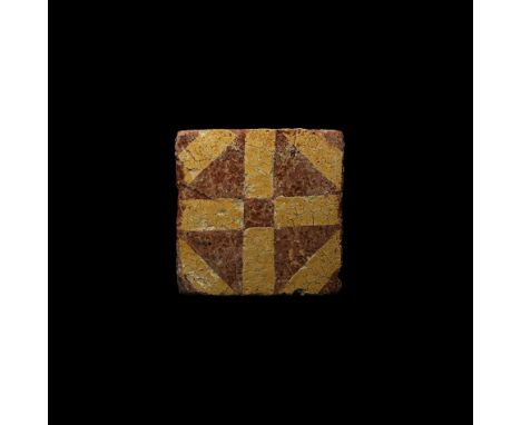 15th century AD. A rectangular glazed ceramic floor tile with geometric pattern of intersecting lozenges and crosses.  1 kg, 