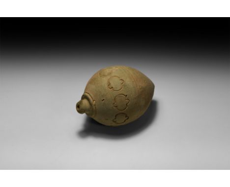 9th-11th century AD. A piriform ceramic vessel with short neck, domed lip and conical base, band of impressed quatrefoils to 