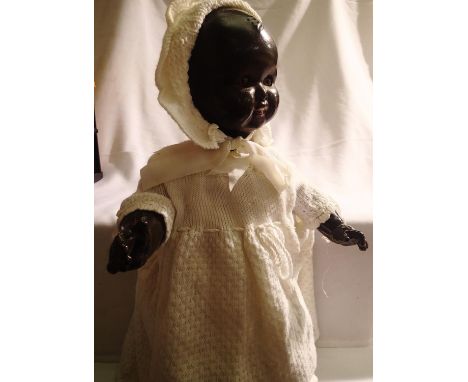 Celluloid black doll approximately 50 cm tall, jointed and sleep eyes, has sound box in back, no working. P&amp;P Group 1 (£1