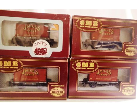 Three OO scale Airfix wagons and a Dapol conflat with J Miles leeds containers, mostly in excellent condition, wear to boxes.