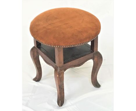 ELM CIRCULAR STOOLwith a stuffover suede seat with decorative stud detail and an open shelf below, standing on cabriole suppo