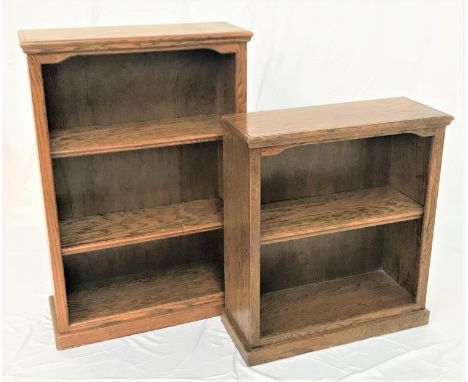 TWO OAK OPEN FRONTED BOOKCASESeach with a moulded top above a shaped frieze, one with two adjustable shelves, 124cm high, the