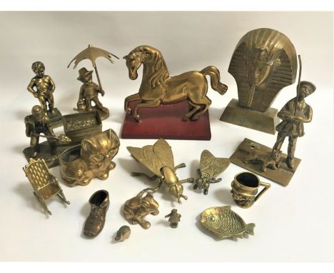 SELECTION OF DECORATIVE BRASS WAREincluding a Pharaohs mask, boy with an umbrella and watering can, a lamp lighter with his d