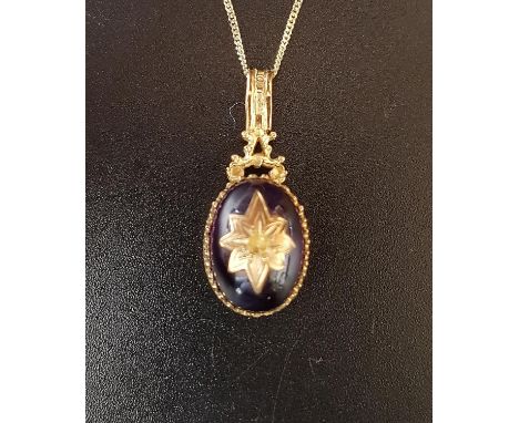 VICTORIAN STYLE AMETHYST PENDANTthe cabochon amethyst in nine carat gold mount and with central gold star decoration, on nine