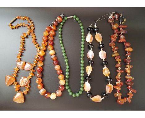 FIVE AGATE AND HARDSTONE BEAD NECKLACESof various designs, four in orange and white tones, one with faceted black bead spacer