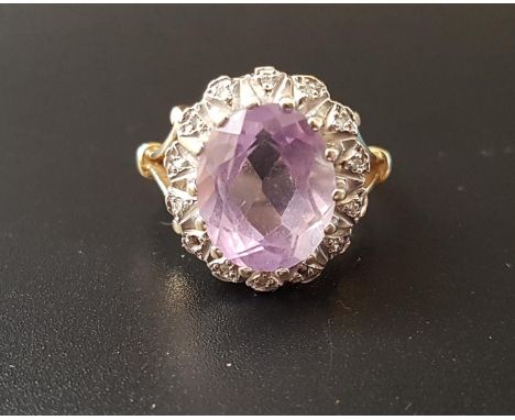 AMETHYST AND DIAMOND CLUSTER DRESS RINGthe central oval cut amethyst in illusion set diamond surround, on nine carat gold sha