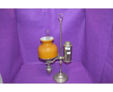 An antique desk top or students oil lamp, having Ochre glass shade and internal chimney.