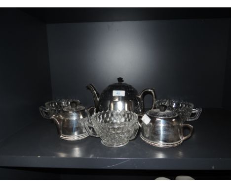 A mid century insulated tea pot, jug and sugar basin, having cream ceramic bodies with chrome covers, some slight patina in p