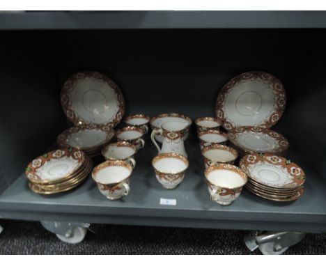A part tea service by Royal Albert Crown China decorated and detailed by hand