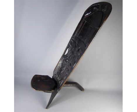 An African Black Hardwood Carved Tribal Birthing Chair; the chair back is approx 107 cms high, the seat forming part of the t