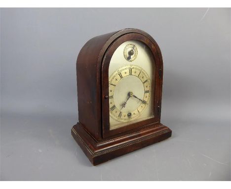 A Mahogany Mantle Clock, the clock having a silvered chapter ring with Roman dial.