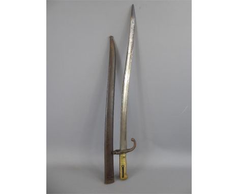 An Antique French Steel and Polished Brass Bayonet in Steel Scabbard, marked to blade armoury 'Mre di Ormes de St Etienne 187