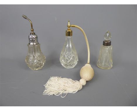 Three Cut Glass Perfume Bottles, the first with tasseled syringe, the second with glass stopper and the third with silver top