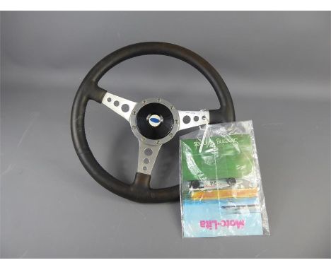 A Vintage Moto Lita Steering Wheel with fitted Ford Boss kit and original booklet.
