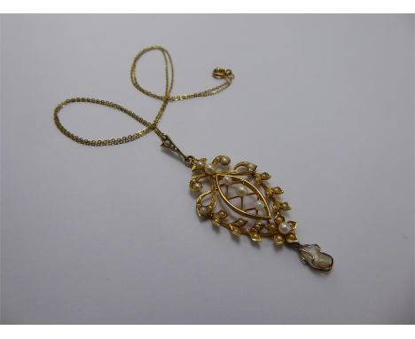 An Edwardian 15ct Yellow Gold Split Pearl Pendant and Chain, suspended on a 9ct gold chain.The pendant drop 55 mm x 22 mm, ap