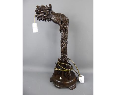 A Carved Wooden Chinese Lamp in the form of a dragon, approx 55 cms high.&nbsp;