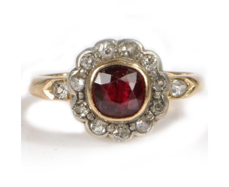 An 18 carat gold ruby and diamond set ring, with a central ruby and diamond surround, 4.2 grams, ring size K