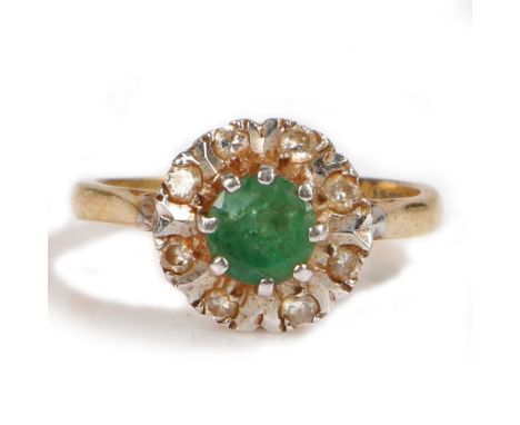 An 18 carat gold emerald and diamond set ring, with a central emerald and diamond surround, 3.6 grams, ring size K