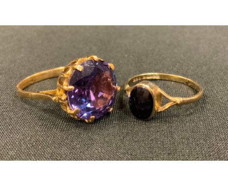 A 9ct gold onyx oval panel dress ring, size Q, 1.6g gross;  a purply blue dress ring, yellow metal shank stamped 18K, size N,