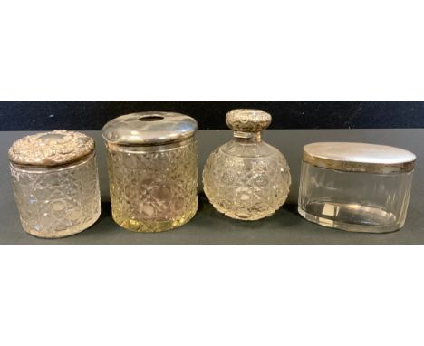 An Edwardian cut glass dressing table jar, silver cover, Birmingham 1903;  a similar hair tidy;  a Victorian silver mounted g