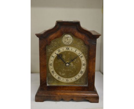 A battery operated walnut mantle clock.