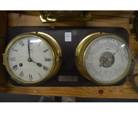 A brass ships clock and matching barometer/thermometer mounted on a hanging board together with a mantle clock.
