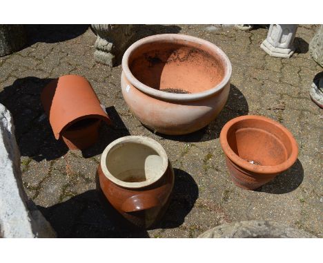 A large terracotta circular planter and three other items.