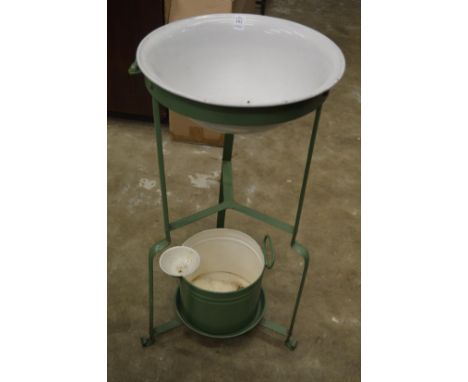 An old enamel and wrought iron wash basin.