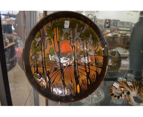 A large Poole pottery Aegean ware charger depicting a landscape with sunset.