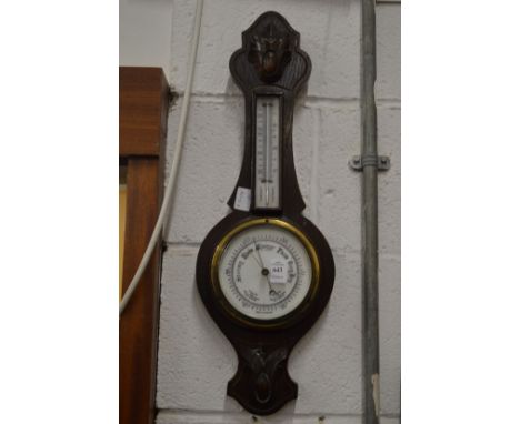 An oak barometer/thermometer.