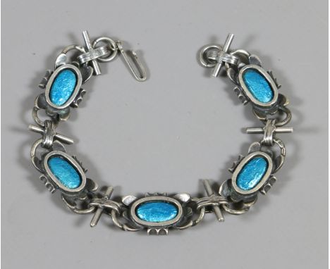 A white metal and enamel bracelet.