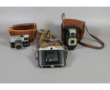 A set of three cased vintage cameras to include a Kodak 66 model, Halina Simplette EE automatic and boxed Brownie.