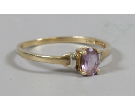 A 9 carat white and yellow gold ring set with a single amethyst, size O.