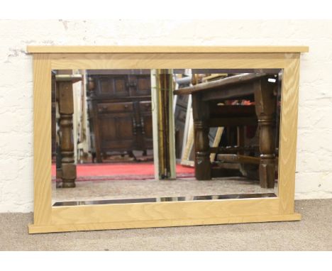 A good quality light oak framed bevel edged wall mirror.